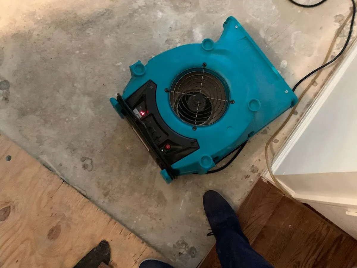 Air mover drying subfloor during Commercial Water Damage Restoration in Hacienda Heights